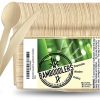 Disposable wooden cutlery set laid out on a table: wooden forks, spoons, and knives in eco-friendly packaging