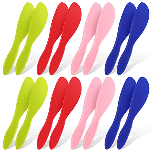 Colorful set of plastic spreaders for butter, cream, and cheese in blue, crimson, pink, and green